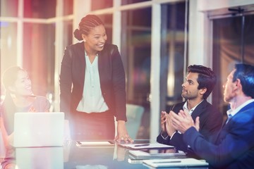 Poster - Coworkers applauding colleague after presentation