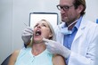 © WavebreakMediaMicro - Dentist examining a woman with tools