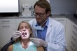 © WavebreakMediaMicro - Dentist examining a woman with tools