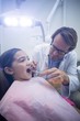 © WavebreakMediaMicro - Dentist examining a young patient with tools