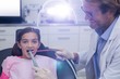© WavebreakMediaMicro - Dentist examining a young patient with tools
