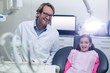 © WavebreakMediaMicro - Portrait of smiling dentist and young patient