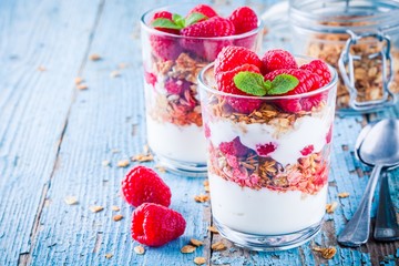 Wall Mural - Healthy breakfast: yogurt parfait with granola and fresh raspberries