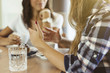 © juripozzi - two young girls talking in a cafeteria