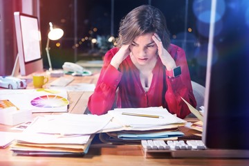 Stressed businesswoman sitting in front of computer