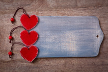 Three Red Hearts On Wooden Background
