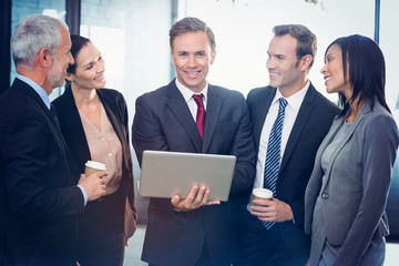 Poster - Business people standing together with laptop