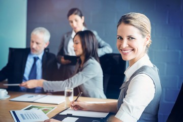 Poster - Portrait of confident businesswoman in business meeting