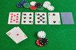 A poker table with cards and chips