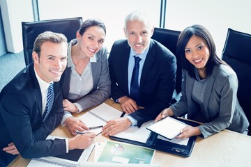 Poster - Portrait of smiling businesspeople in conference room