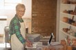 © WavebreakMediaMicro - Portrait of female potter making note from laptop