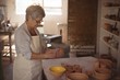 © WavebreakMediaMicro - Female potter pouring watercolor in bowl