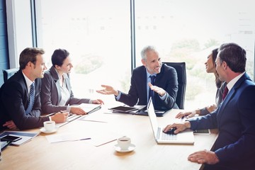 Poster - Happy businesspeople discussing in conference room