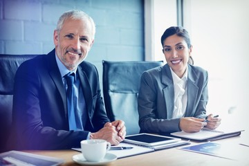 Poster - Businessman and businesswoman sitting in conference room