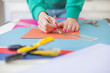 © nikodash - Young woman make scrapbook of the papers on the table using antique tools for cutting paper. Hand made photo album.Shallow depth of field