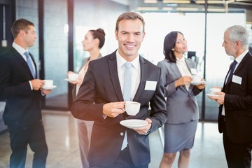 Poster - Portrait of businessman having tea during break time