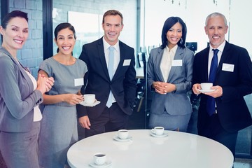 Poster - Portrait of businesspeople having tea during breaktime