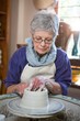 © WavebreakMediaMicro - Attentive female potter making pot