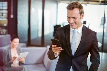Poster - Businessman looking at mobile phone