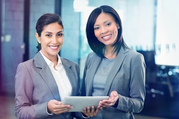Poster - Happy businesswomen with digital tablet