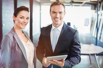 Poster - Portrait of businessman and businesswoman holding digital tablet