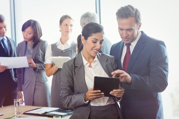 Poster - Businessman and businesswoman using digital tablet