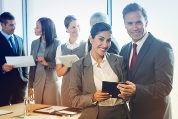 Poster - Portrait of businessman and businesswoman holding digital tablet