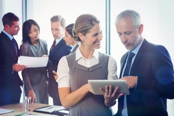 Poster - Businessman and businesswoman using digital tablet together