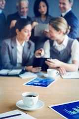 Poster - Cup of coffee on table in conference room