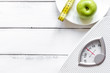 © 279photo - floor scale and apple on wooden background top view