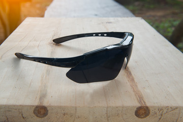 Black glasses on wood table background