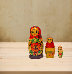 Wall Mural - Matryoshka, national russian doll on wooden table