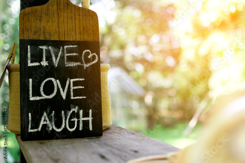 Close up label "LIVE LOVE LAUGH"on coffee shop. Poster
