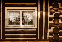 Log Cabin With Flowers In Window
