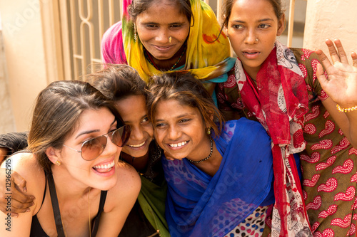 Tourist taking photos with cute Indian girls Poster