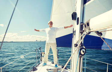 Canvas Print - senior man on sail boat or yacht sailing in sea