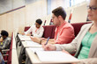 © Syda Productions - group of students with notebooks in lecture hall
