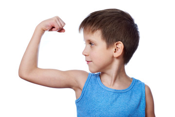 Wall Mural - Little athletic boy looking at the biceps muscle isolated