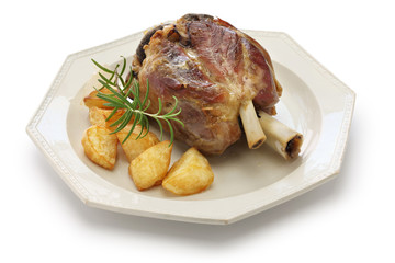 pork shank with roasted potatoes, stinco di maiale con patate arrosto, italian cuisine isolated on white background
