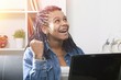 © carballo - young woman happy with the computer laptop at home celebrating the success