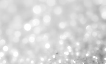 Silver And White Bokeh Lights Defocused. Abstract Background