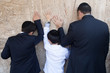 Father and son pray to God at the Wailing Wall. Jerusalem.