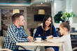 © romankosolapov - Family Enjoying tea In Cafe Together
