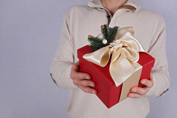 Man holding red present with white Ribbon close up. Gift box. , New year, Christmas concept.