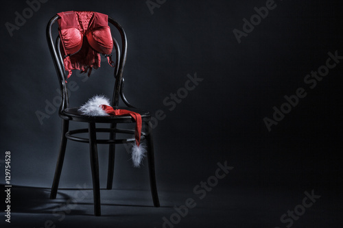 women-s-underwear-and-hat-of-santa-claus-hanging-on-a-retro-chair-erotic-christmas-motif