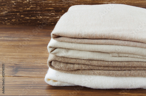 Fotografía Stack of knitted clothes in nude beige tones