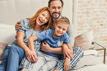 Happy family of three at home