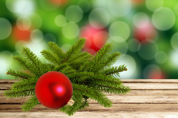 Christmas holiday background with tree branch and red ball on wo