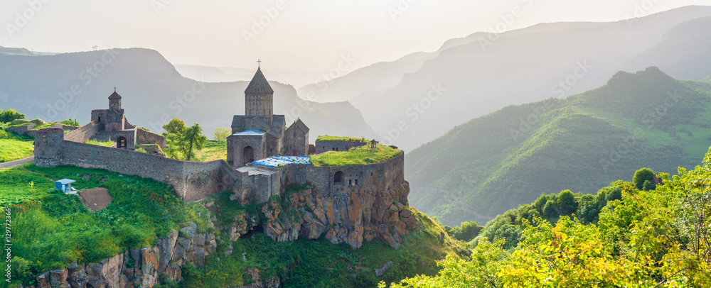 Beautiful view of ancient monastery in setting sun. Tatev. Armenia - obrazy, fototapety, plakaty 