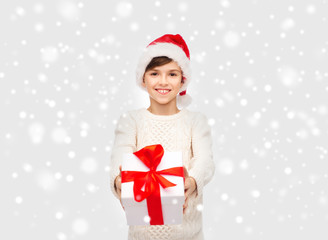 smiling happy boy in santa hat with gift box